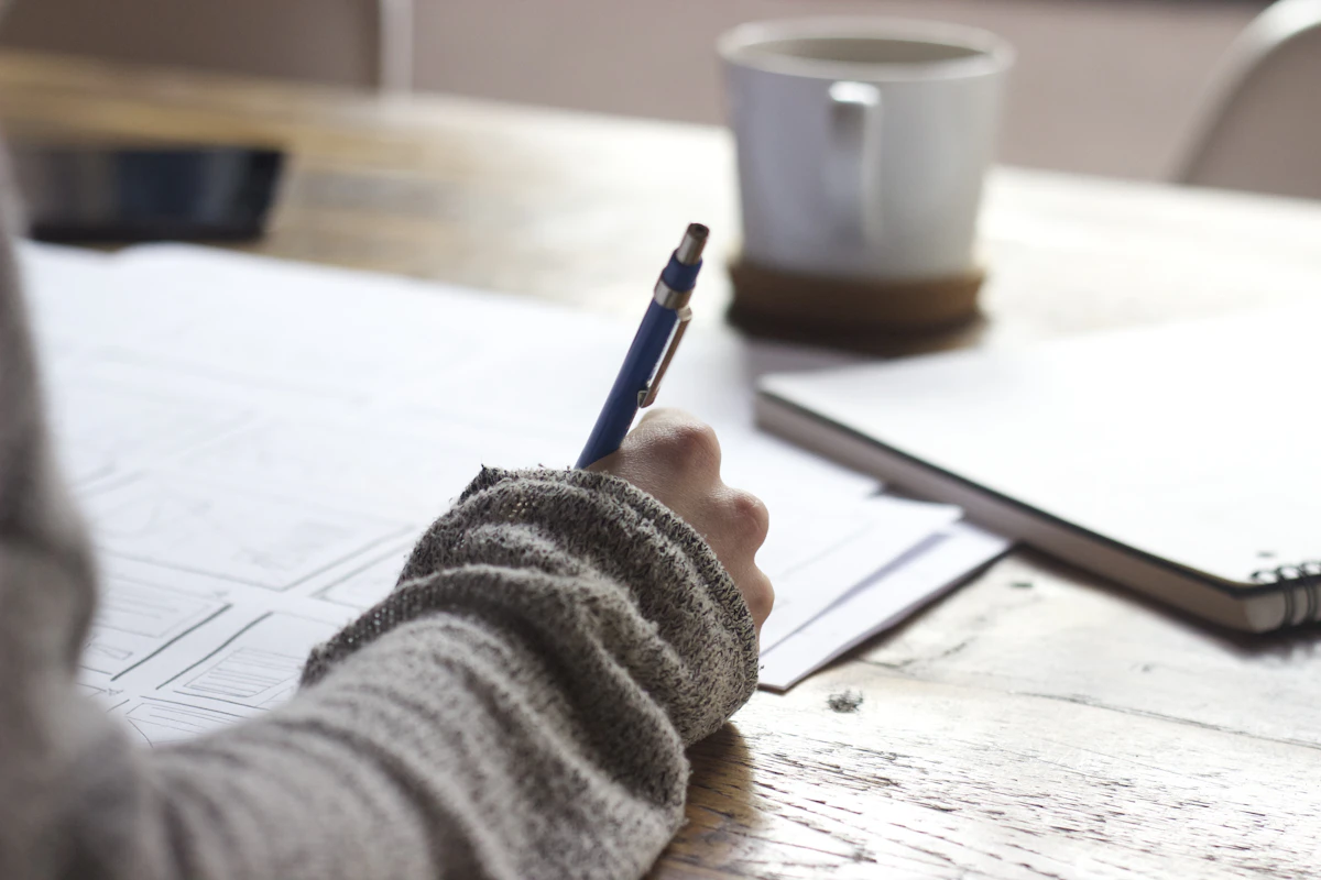 Researcher reviewing a manuscript at a desk